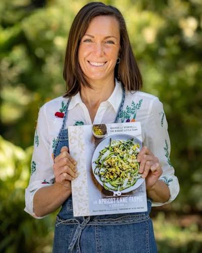 Molly Chester holding the Apricot Lane Farms Cookbook